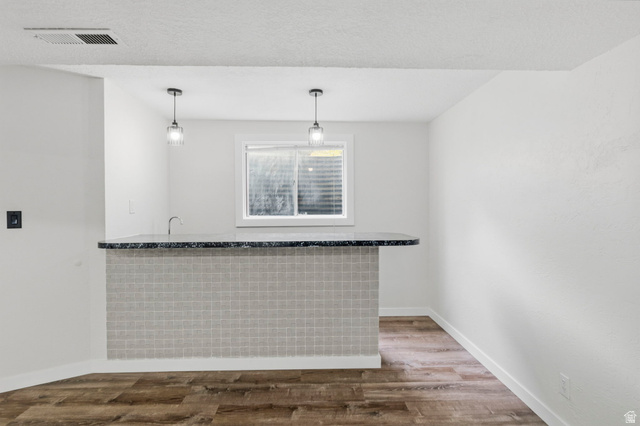 2693 Teal Way Sandy, UT 84093 - Photo 26 of 50 Built-in bar with a dark countertop and square-tiled facade