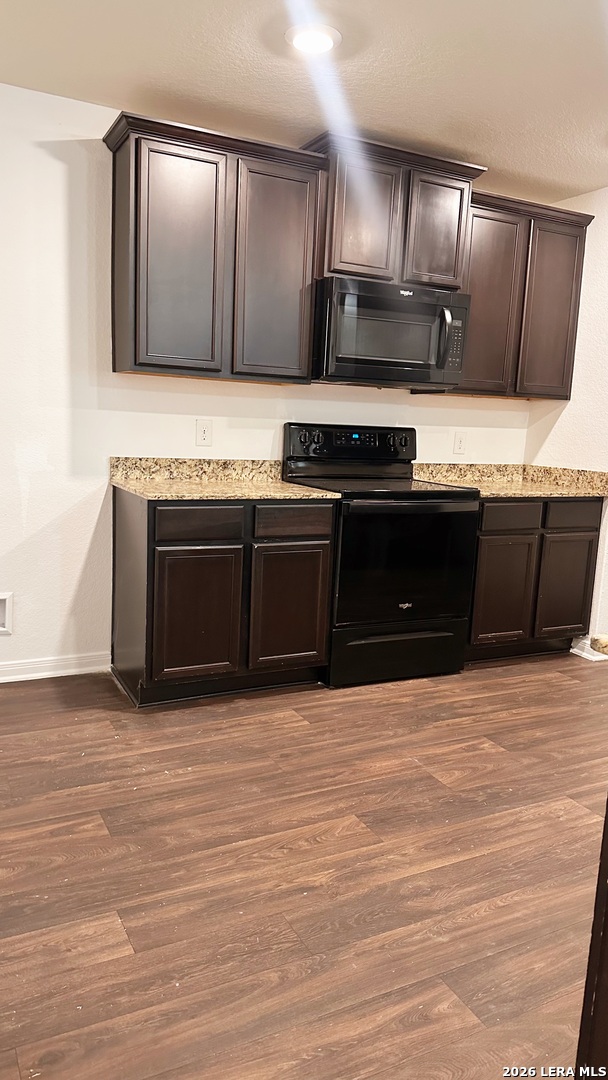 15230 Walcott Von Ormy, TX 78073 - Photo 5 of 10 a kitchen with stainless steel appliances kitchen island granite countertop a stove top oven and granite counter tops