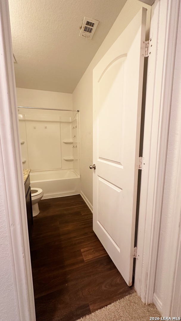 15230 Walcott Von Ormy, TX 78073 - Photo 9 of 10 a view of walk in closet with wooden floor
