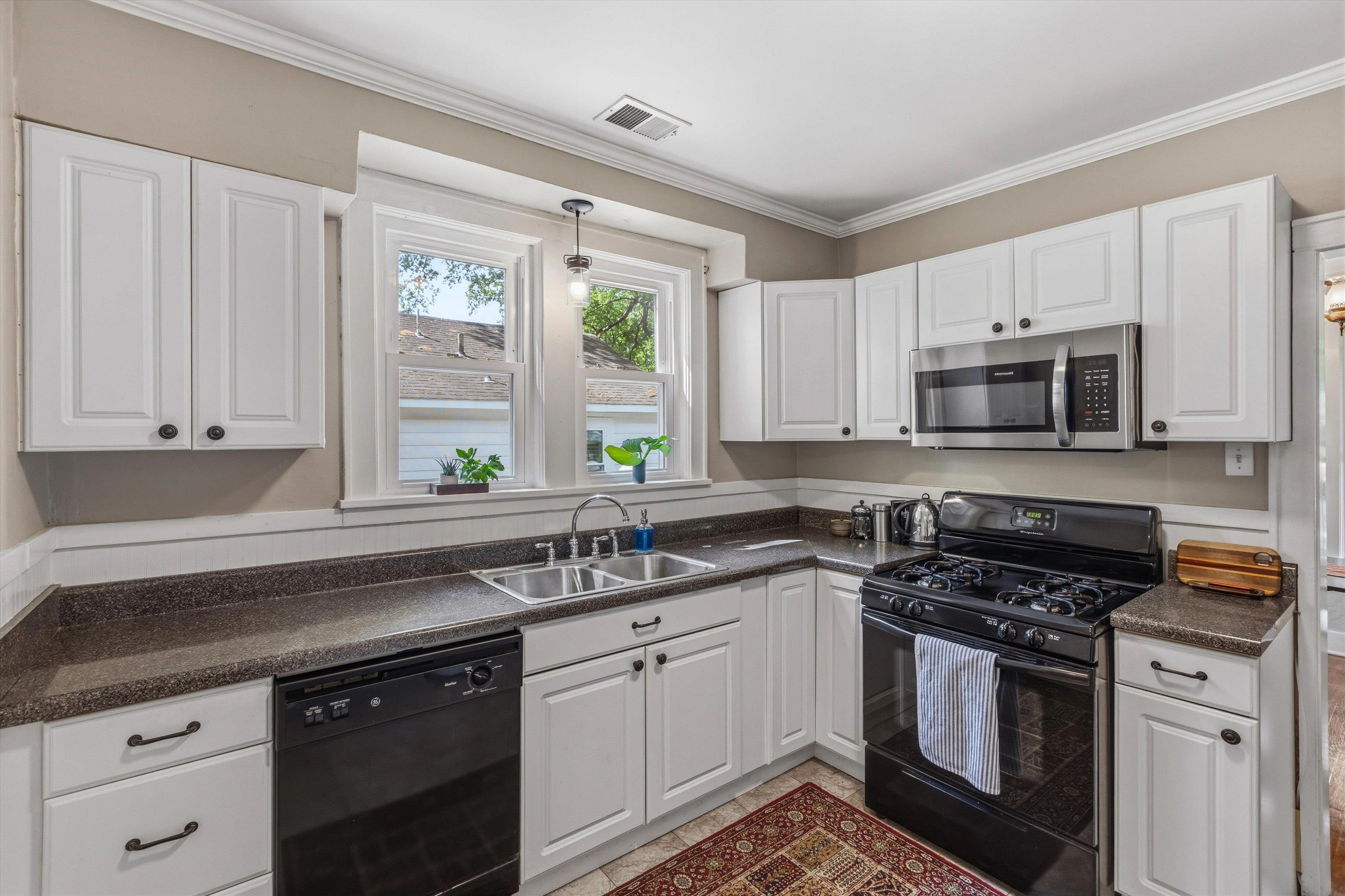 564 Alexander Street Memphis, TN 38111 - Photo 11 of 30 a kitchen with white cabinets and appliances