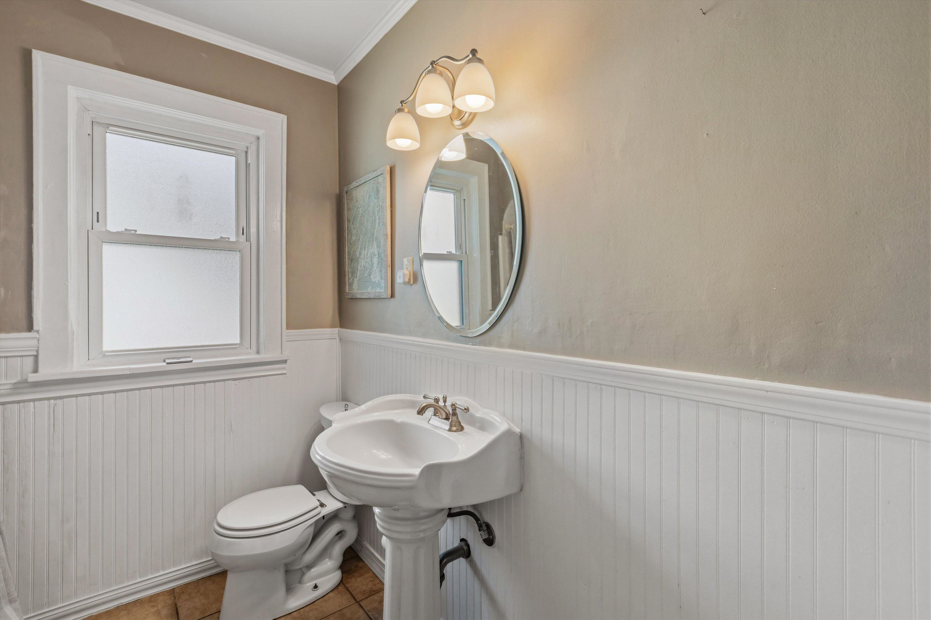 564 Alexander Street Memphis, TN 38111 - Photo 19 of 30 a bathroom with a toilet sink and mirror