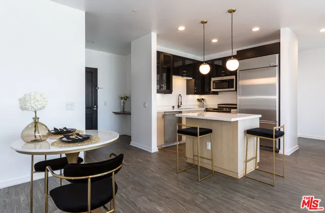 a kitchen with kitchen island stainless steel appliances a sink and stove