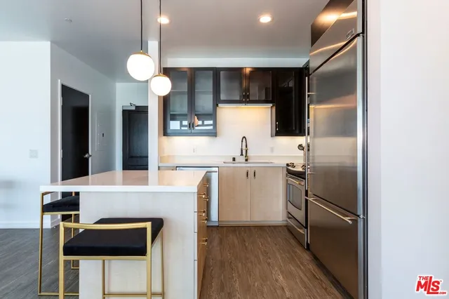 a kitchen with refrigerator cabinets and a sink