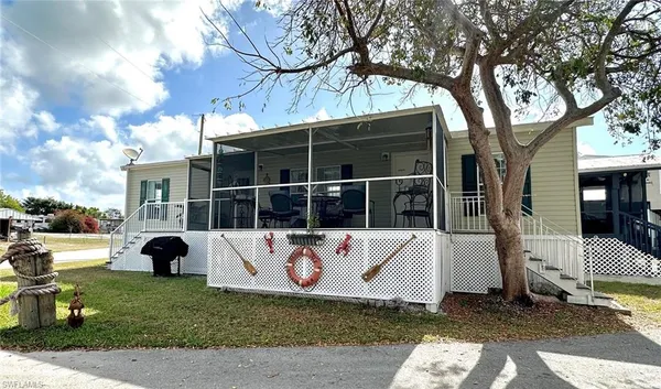 a view of a house with a window and a tree