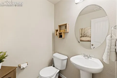 a bathroom with a sink mirror and toilet