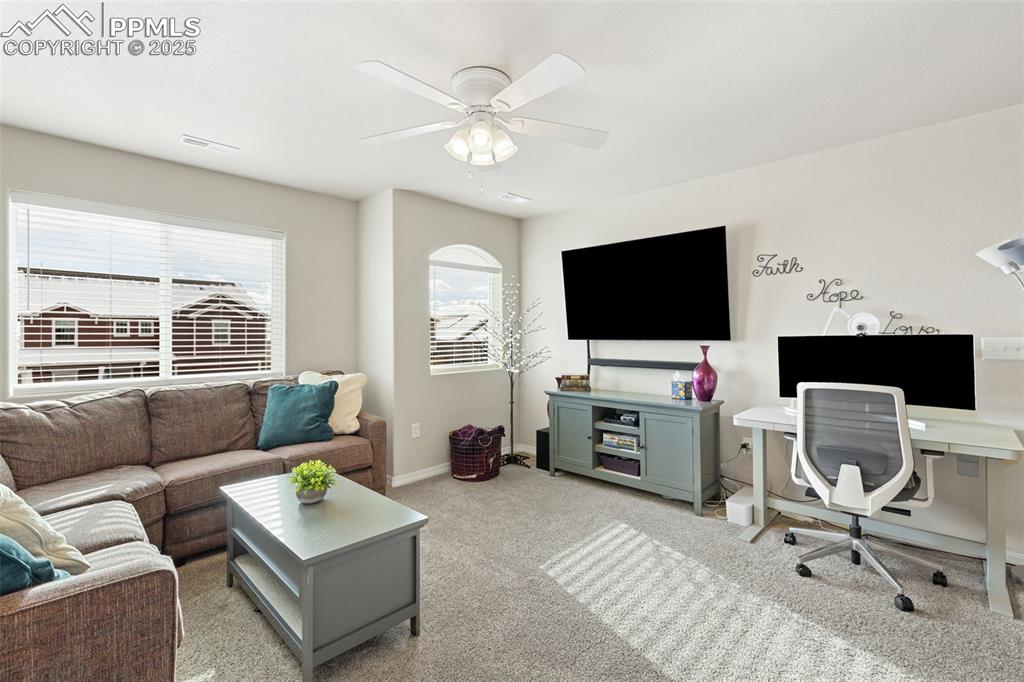 7228 New Meadow Drive Colorado Springs, CO 80923 - Photo 15 of 35 a living room with furniture and a flat screen tv