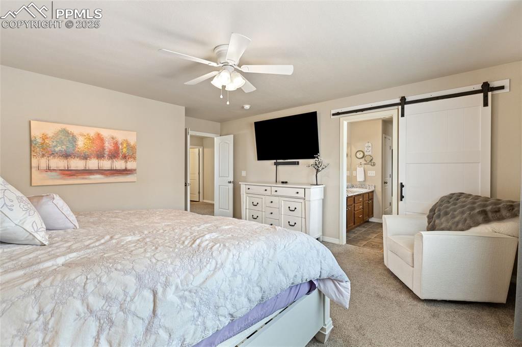 7228 New Meadow Drive Colorado Springs, CO 80923 - Photo 17 of 35 a spacious bedroom with a bed and a television