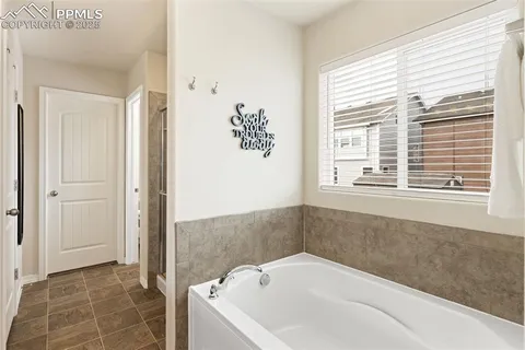 a bathroom with a bathtub and window