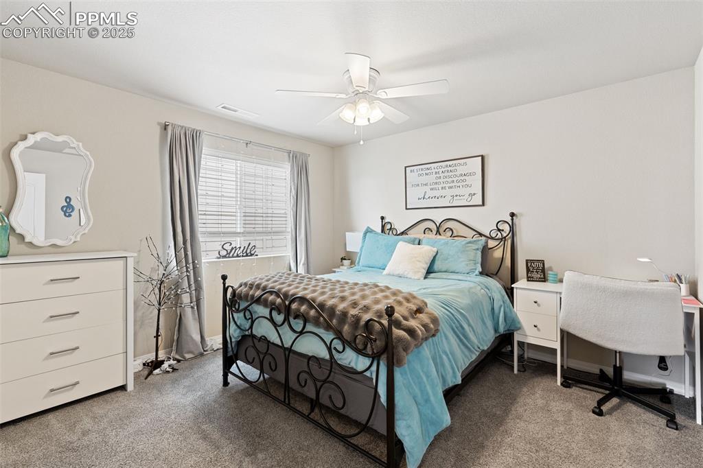 7228 New Meadow Drive Colorado Springs, CO 80923 - Photo 20 of 35 a bedroom with a bed and a dresser