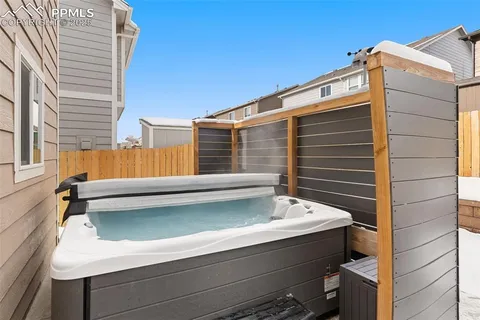 a view of backyard with barbeque and wooden stairs