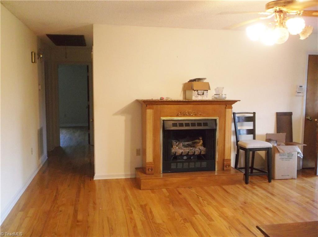 1099 Edwards Road Rural Hall, NC 27045 - Photo 12 of 20 Living Room with free-standing fireplace, beautiful hardwood flooring.