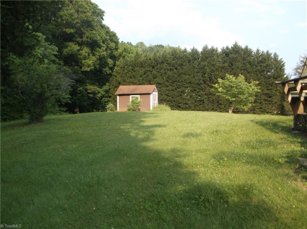 1099 Edwards Road Rural Hall, NC 27045 - Photo 8 of 20 Additional storage building, to the left is part of acreage which is wooded, nice shaded back yard,large back deck.