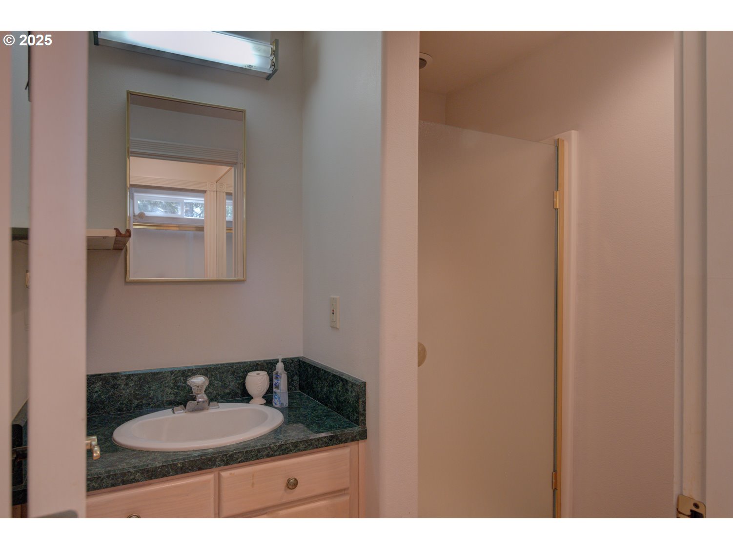 87630 Woodmere East Florence, OR 97439 - Photo 13 of 25 a bathroom with a granite countertop sink and a mirror