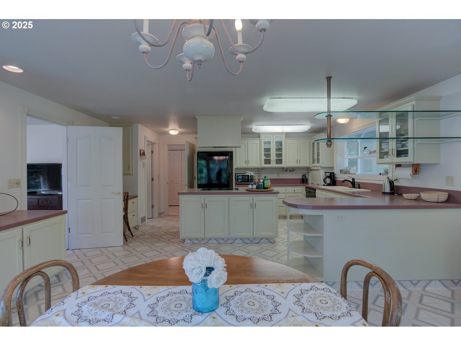 87630 Woodmere East Florence, OR 97439 - Photo 9 of 25 a kitchen with stainless steel appliances kitchen island granite countertop a table and chairs