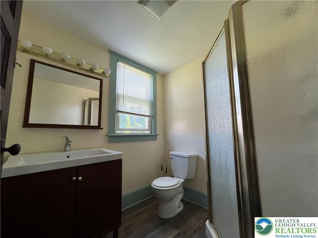 a bathroom with a toilet sink and mirror