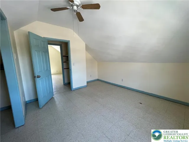 a view of a room with a ceiling fan