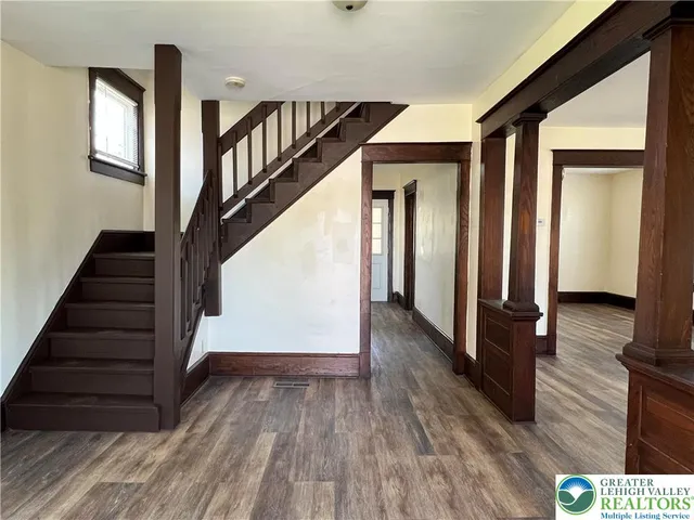 a view of entryway and hall with wooden floor