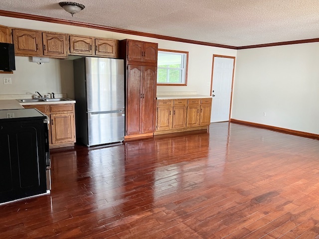 320 Prospect Street Dixon, IL 61021 - Photo 4 of 23 a view of a kitchen with wooden floor and a refrigerator
