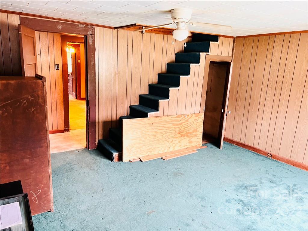 4080 Piney Road Morganton, NC 28655 - Photo 12 of 26 an empty room with windows and stairs