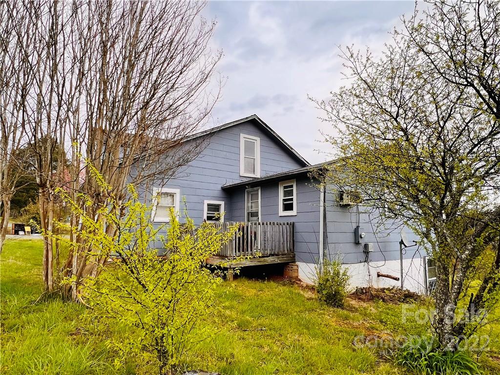 4080 Piney Road Morganton, NC 28655 - Photo 4 of 26 a view of a house with wooden fence next to a large tree