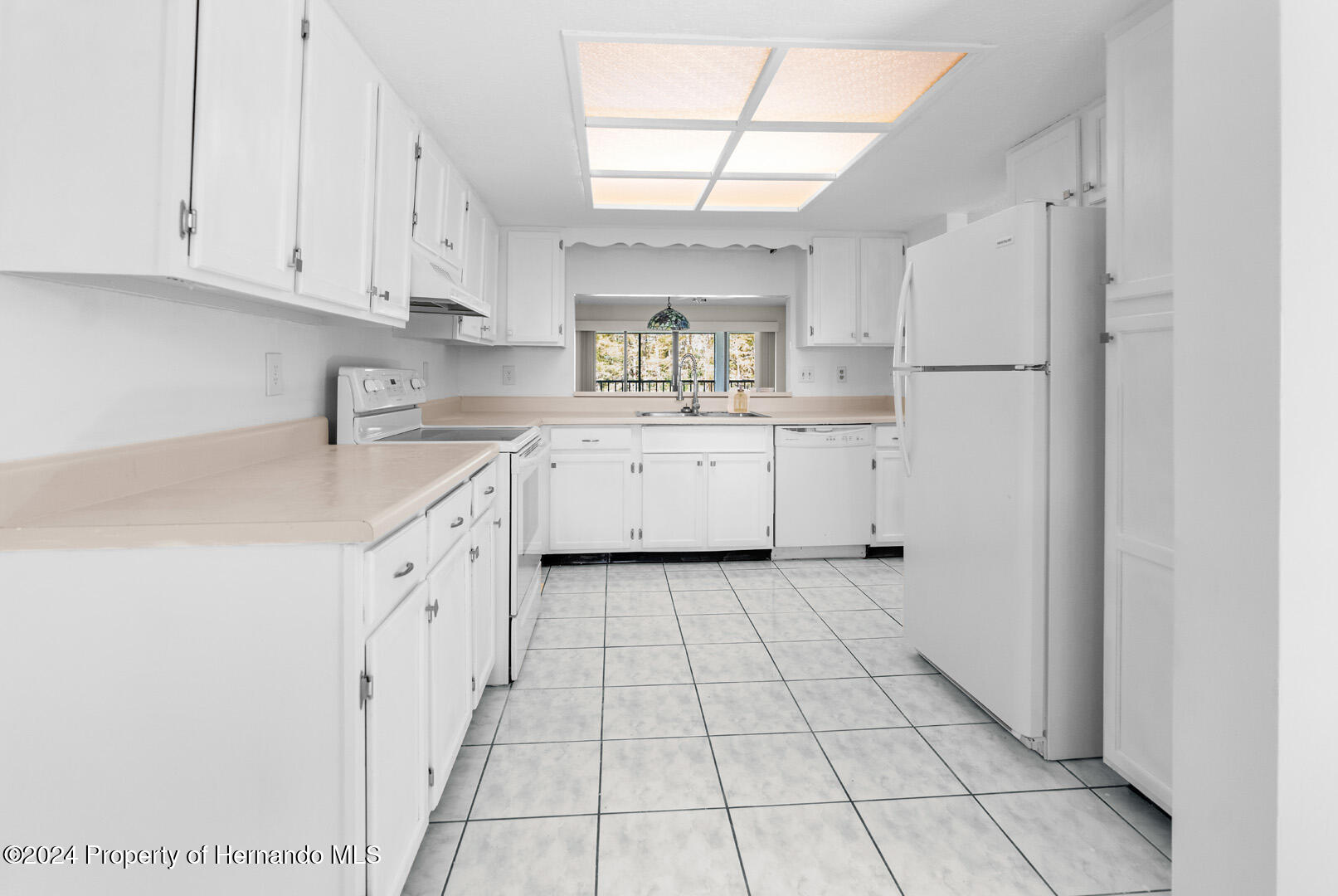 7721 Cosme Drive Hudson, FL 34667 - Photo 11 of 28 a kitchen with appliances cabinets and a sink