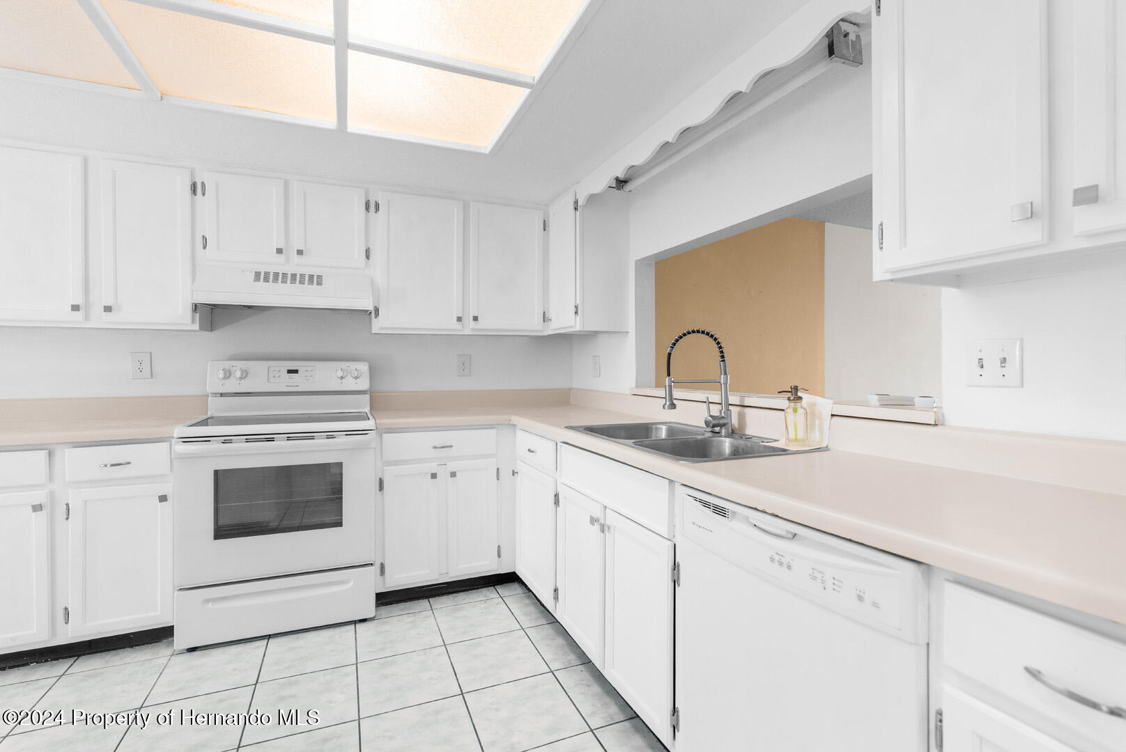 7721 Cosme Drive Hudson, FL 34667 - Photo 13 of 28 a kitchen with granite countertop white cabinets and white appliances