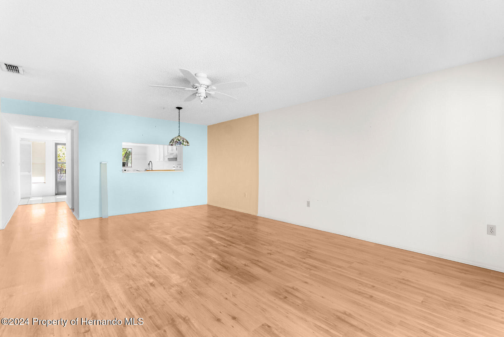 7721 Cosme Drive Hudson, FL 34667 - Photo 16 of 28 a view of empty room with wooden floor