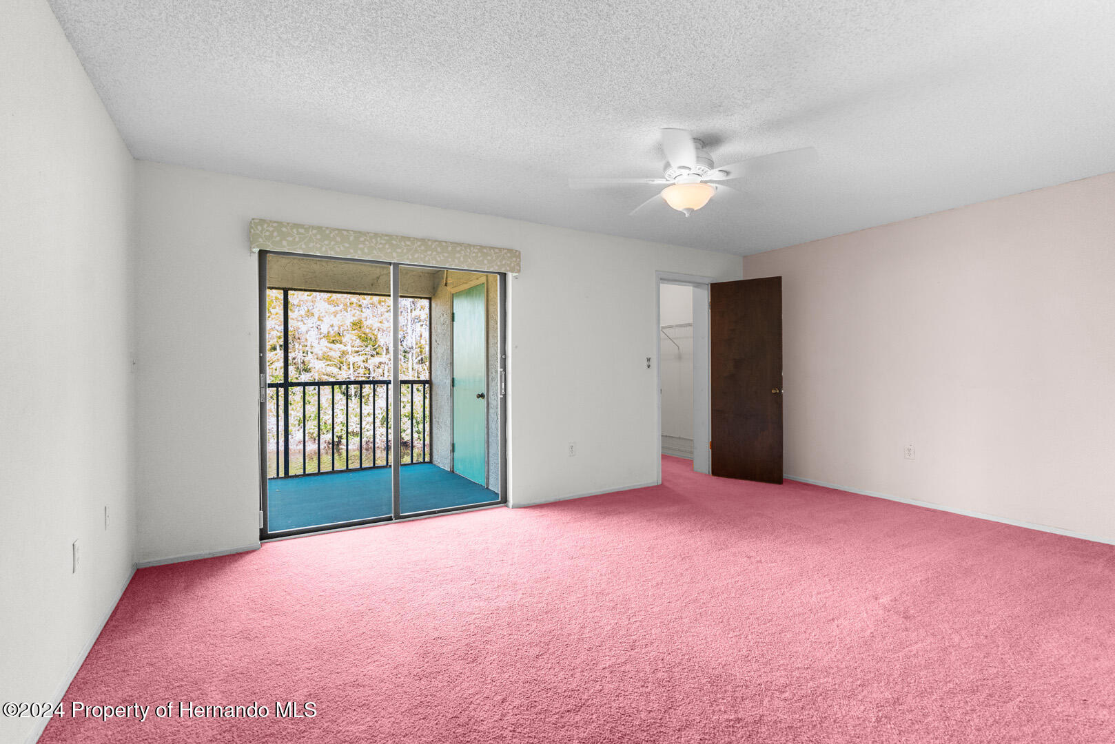 7721 Cosme Drive Hudson, FL 34667 - Photo 17 of 28 an empty room with a ceiling fan and a window