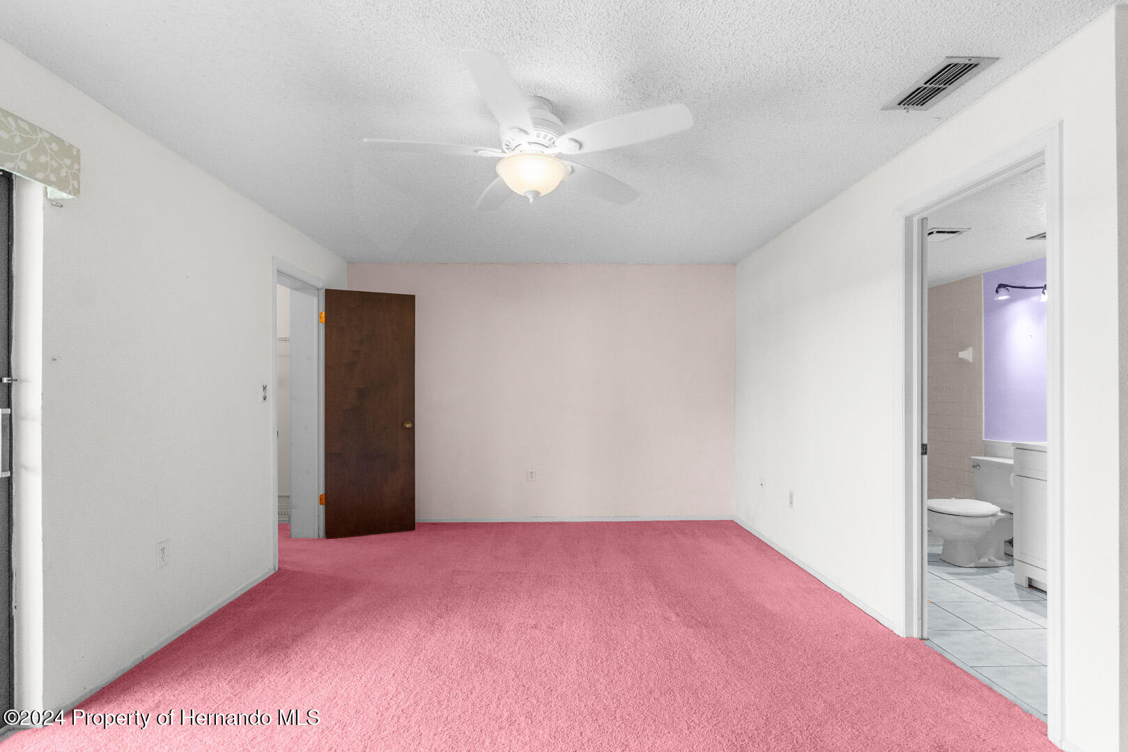 7721 Cosme Drive Hudson, FL 34667 - Photo 18 of 28 a furnished livingroom with a ceiling fan and bathroom space