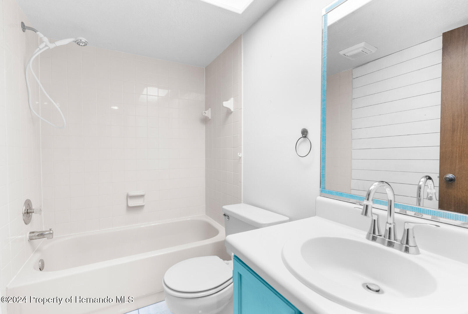 7721 Cosme Drive Hudson, FL 34667 - Photo 23 of 28 a bathroom with a bathtub shower sink vanity mirror and toilet