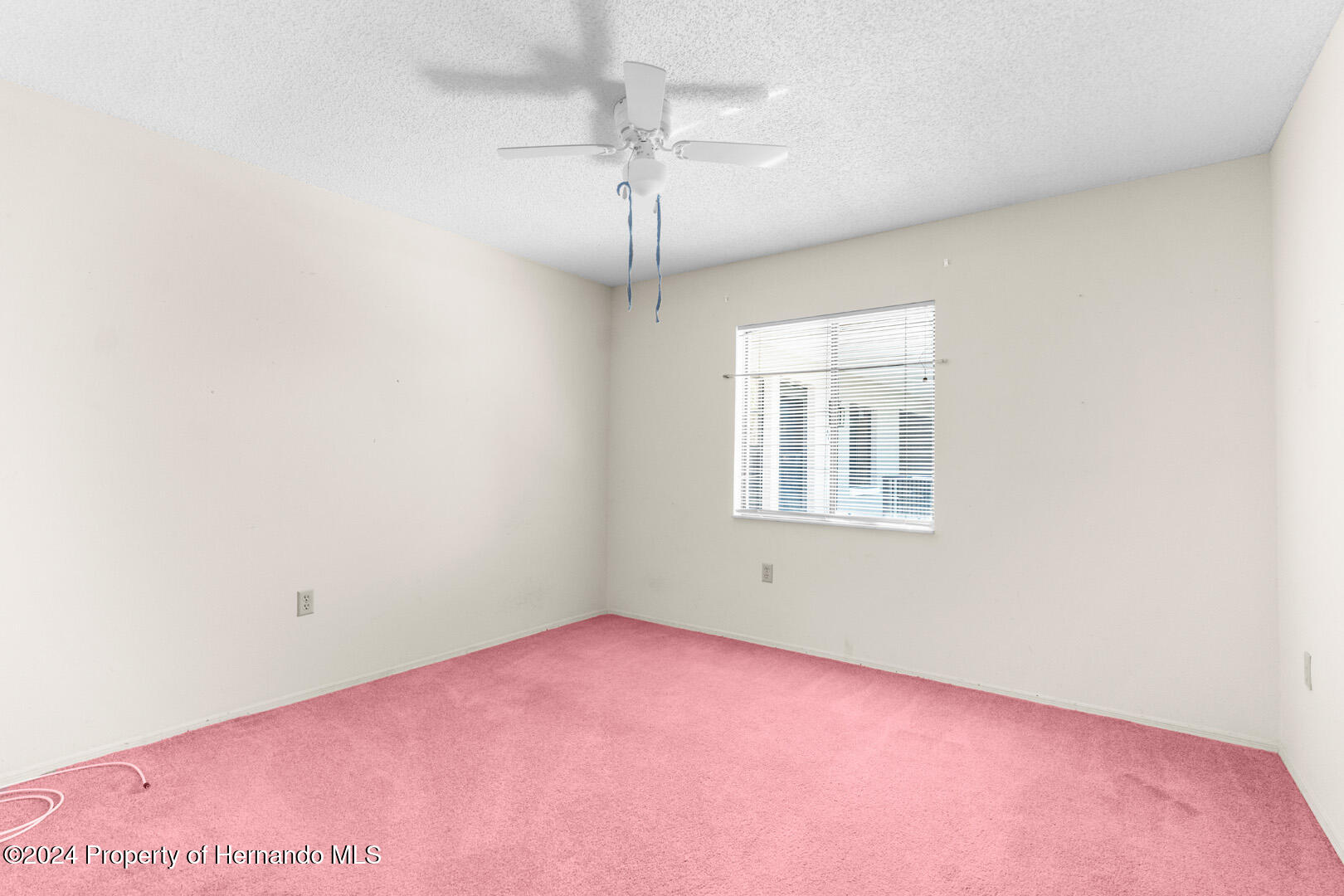 7721 Cosme Drive Hudson, FL 34667 - Photo 24 of 28 an empty room with a window and a fan
