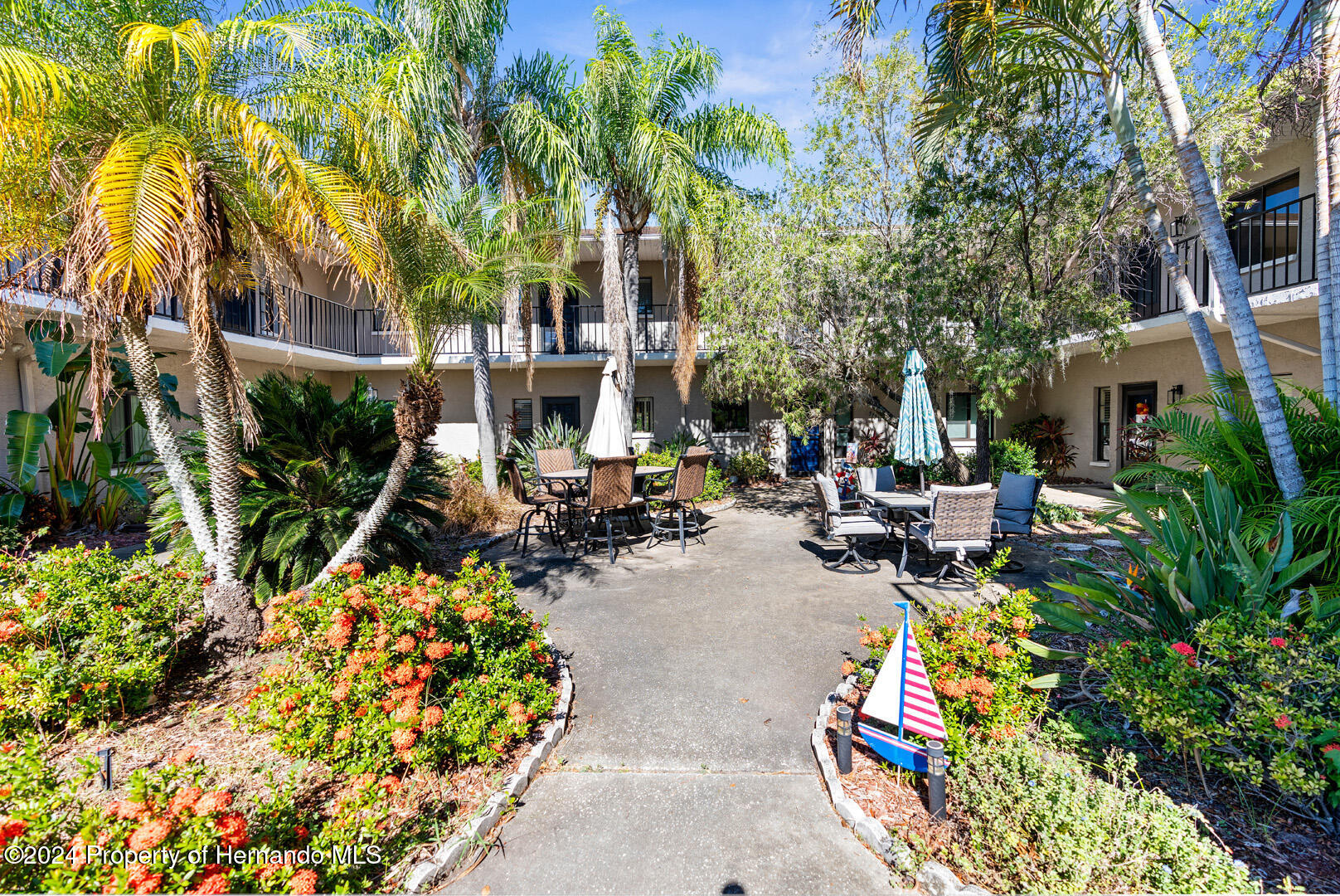 7721 Cosme Drive Hudson, FL 34667 - Photo 3 of 28 a view of a patio with table and chairs and potted plants