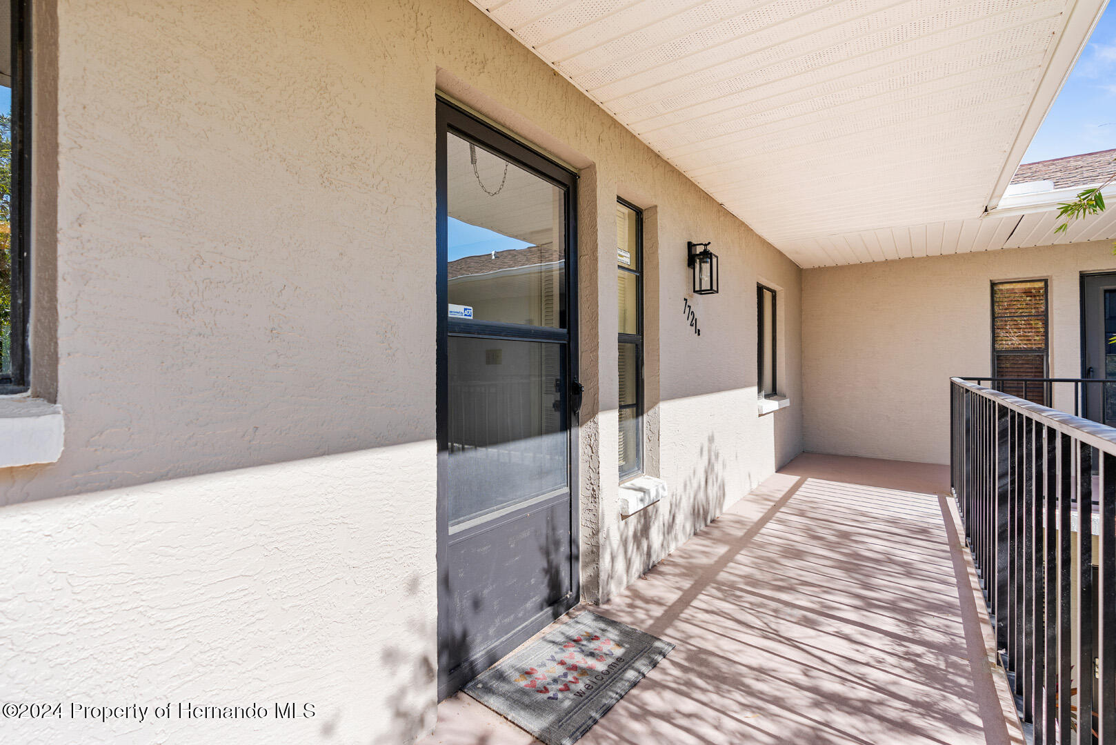 7721 Cosme Drive Hudson, FL 34667 - Photo 7 of 28 a view of a hallway with wooden floor and living room