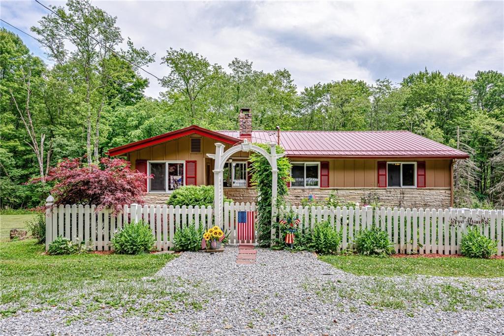 174 Keffer Road Dawson, PA 15428 - Photo 1 of 28 a front view of a house with a garden