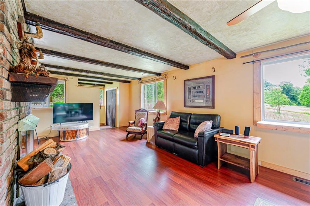 174 Keffer Road Dawson, PA 15428 - Photo 11 of 28 a living room with furniture a flat screen tv and a fireplace