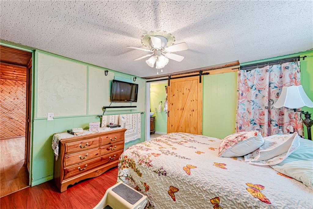 174 Keffer Road Dawson, PA 15428 - Photo 20 of 28 a bedroom with a bed and a flat screen tv