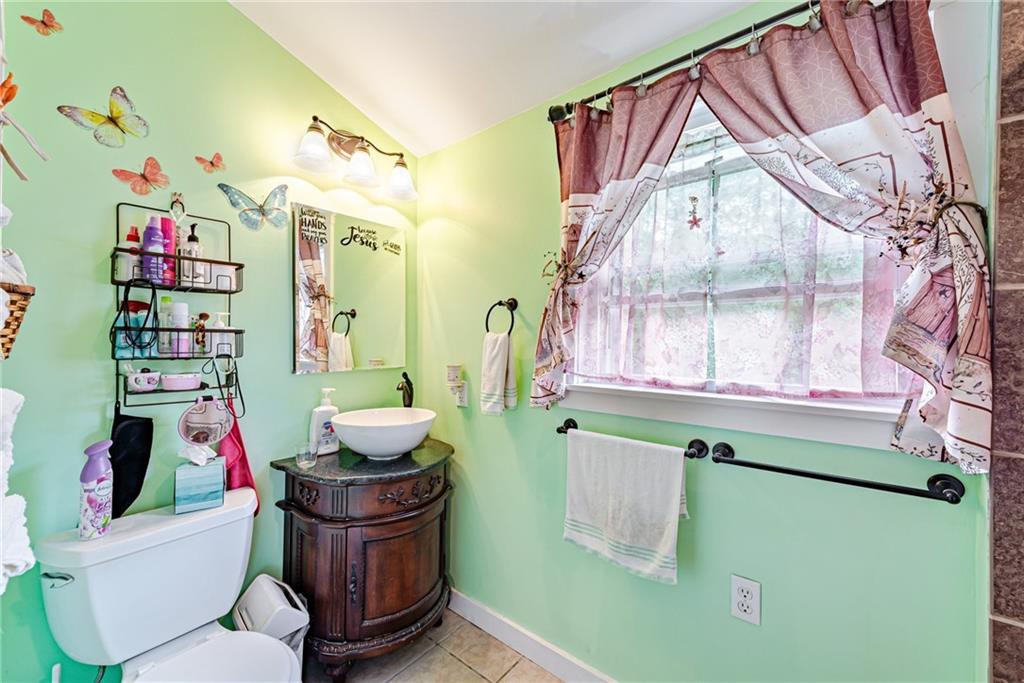 174 Keffer Road Dawson, PA 15428 - Photo 21 of 28 a bathroom with a mirror a sink and a toilet
