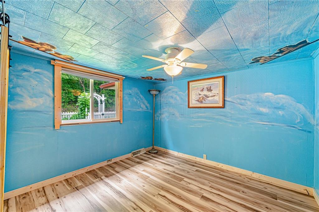174 Keffer Road Dawson, PA 15428 - Photo 24 of 28 a view of a big room with wooden floor and chandelier