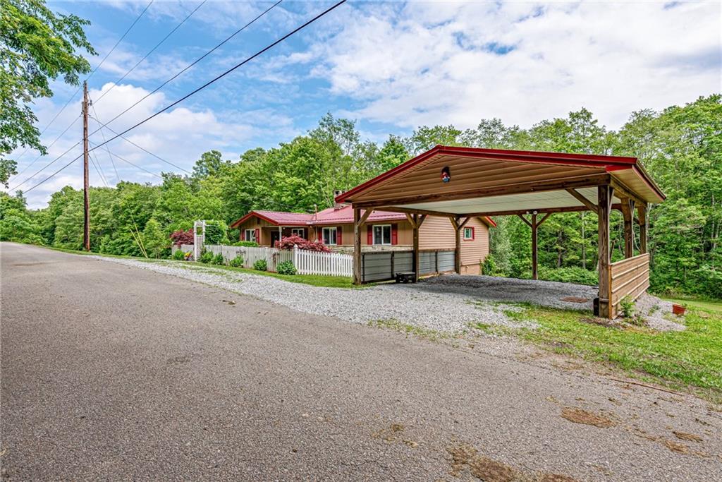 174 Keffer Road Dawson, PA 15428 - Photo 3 of 28 a view of a patio with a table and chairs under an umbrella