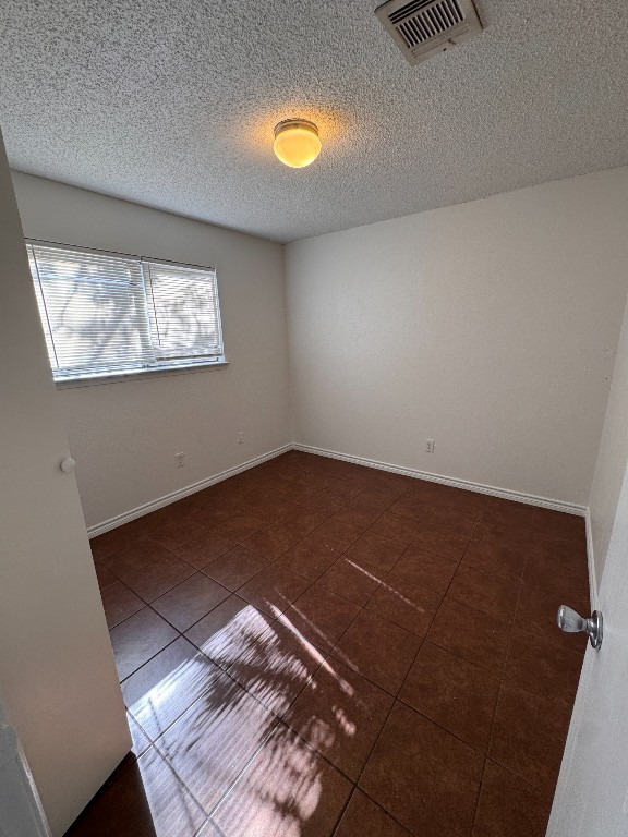 11405 Ptarmigan Drive, Unit A Austin, TX 78758 - Photo 12 of 20 an empty room with wooden floor fan and windows