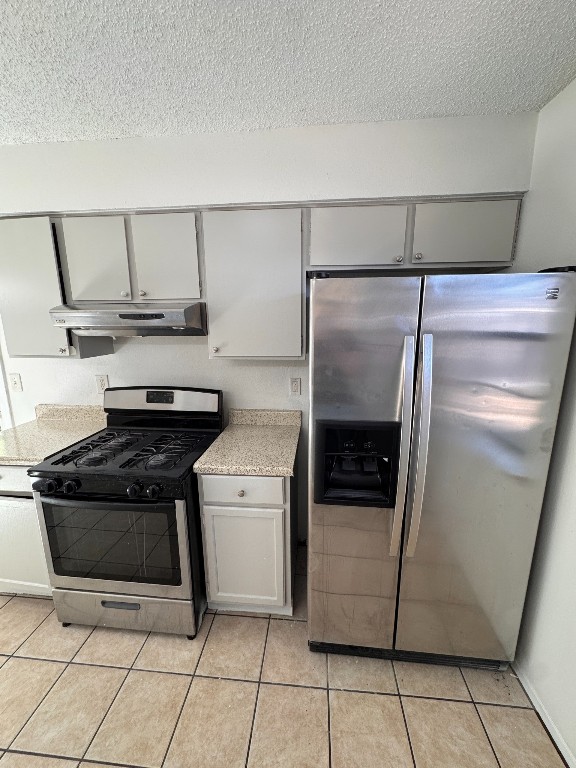 11405 Ptarmigan Drive, Unit A Austin, TX 78758 - Photo 7 of 20 a kitchen with a refrigerator and a stove