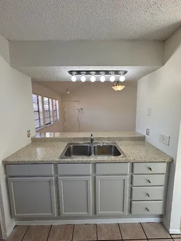 a kitchen with cabinets appliances and a kitchen counter top
