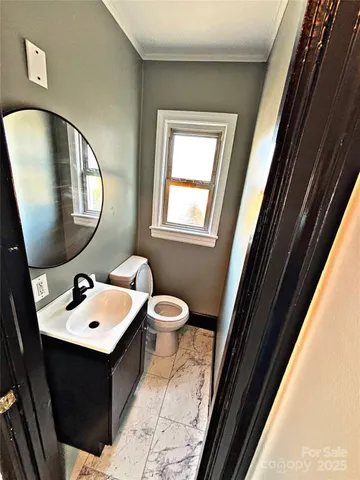 a bathroom with a sink mirror and toilet