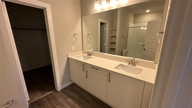 a bathroom with a double vanity sink and mirror