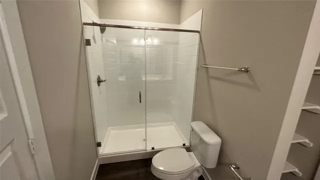 a bathroom with a toilet and a shower