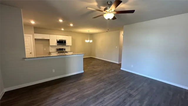 a view of a kitchen with a sink and a stove top oven
