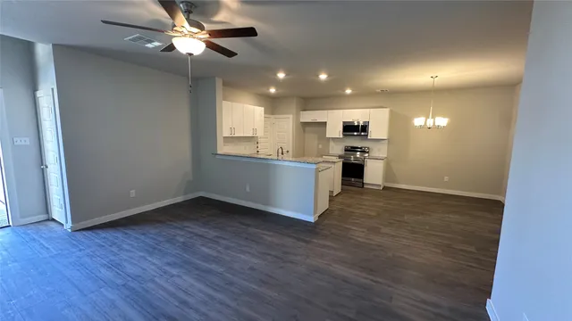 a view of a kitchen with a sink cabinets and wooden floor