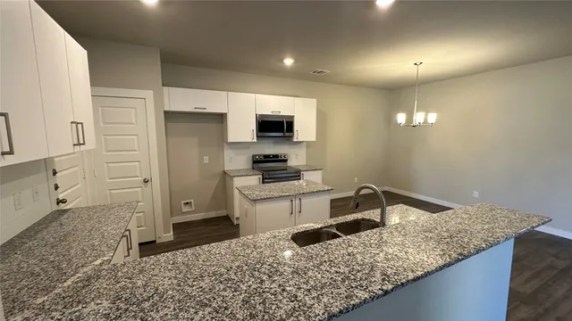 a kitchen with a sink stove and refrigerator