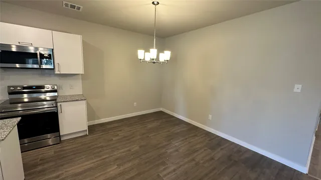 a kitchen with stainless steel appliances a stove top oven a sink and dishwasher