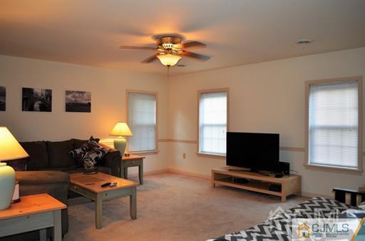 596 Old Post Road Edison, NJ 08817 - Photo 12 of 13 a living room with furniture a flat screen tv and a window